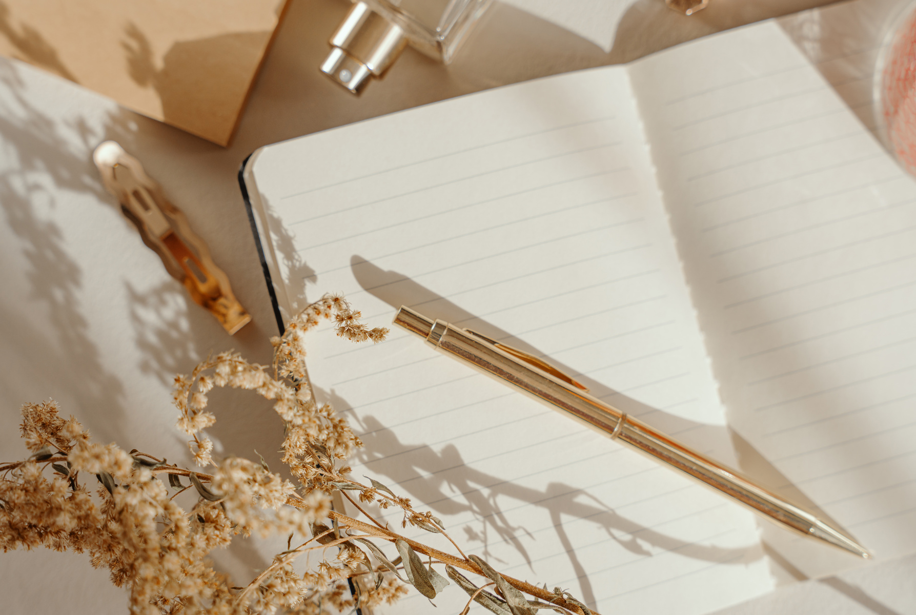 Notebook and gold items, flat lay, beige aesthetic