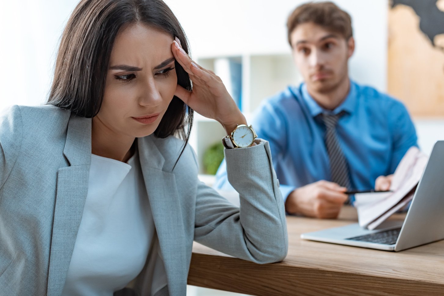 selective focus of offended woman near discouraged travel agent